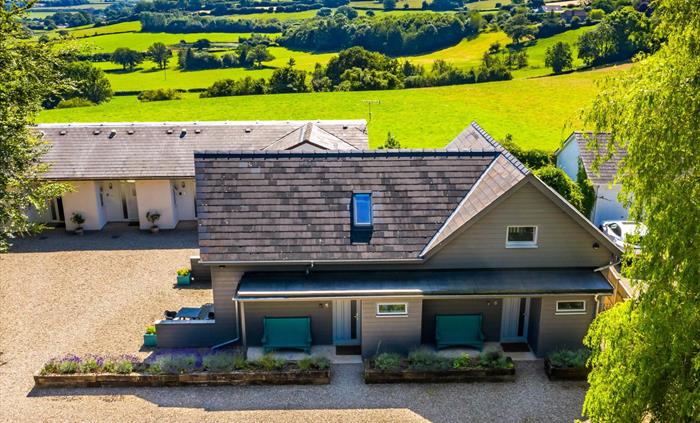 Drone shot of Rock Lodge with rolling countryside beyond